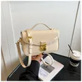 Chic cream patent leather handbag with gold metal clasp and adjustable shoulder strap - Beige