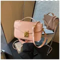 Chic pink patent leather handbag with gold metal lock and adjustable shoulder strap - Pink