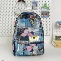 Mini denim backpack with blue butterfly print and fringe details in a study desk setting - No Pendant / Dark Blue