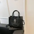 Black studded tote bag with rhinestone skull detail and adjustable shoulder strap - Black