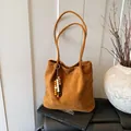 Retro caramel suede tote bag for women featuring ethnic wood and ceramic beaded charms - Brown