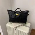 Κομψή μαύρη καπιτονέ τσάντα tote με χρυσό κούμπωμα και ρυθμιζόμενο λουράκι ώμου - Μαύρο