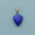 Detailed view of faceted lapis lazuli shield pendant with golden bead-edged clasp - Lapis Lazuli
