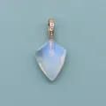 Macro view of faceted shield-shaped moonstone pendant with detailed golden beaded bail - Opal