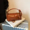Caramel brown vintage pillow handbag in cylinder shape with golden metal ring and knot detail - Brown PU (No Charm)