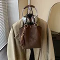 Σκούρα καφέ τσάντα nubuck με αστραφτερούς φιόγκους από στρας και μακριά κρόσσια - Καφέ με Μενταγιόν