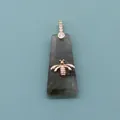 Detailed view of gray labradorite stone pendant featuring a golden bee ornament - Flash Stone (Labradorite)