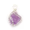 Macro detail of hand-wrapped silver wire around a purple raw crystal stone pendant - Amethyst