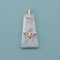 Translucent white stone trapezoid pendant featuring a gold honeybee and diamond-set bail - White Crystal
