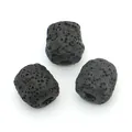 Macro detail of three black lava stone cylinder beads showing natural porous texture - Black