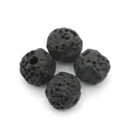 Macro detail of natural black lava rock round beads with porous texture and through holes - No.1 (Black)