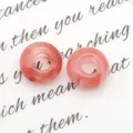 Twee roze doorschijnende natuursteen donut kralen met marmeren textuur voor DIY sieraden - Watermeloen Kwarts