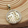Macro detail of gold-plated Fu character shell pendant with sparkling zircon border - White Mother of Pearl