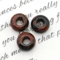 Natuurlijke donutvormige stenen kralen in bruin en zwart voor DIY sieraden maken - Zwanensteen