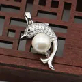 Detailed shot of dolphin-shaped silver pendant with white pearl and sparkling crystals - White Pearl Dolphin Shape (1014-B250606028)