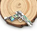 Macro shot of silver pistol pendant with rainbow abalone shell inlay and Desert Eagle engraving - Pistol Shape / 39x55mm