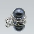 Macro view of dark grey shell pearl pendant with silver diamond-set floral base - Black Pearl Three-Petal Flower (1014-B250606028) / Black
