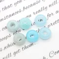 Set van zes lichtblauwe natuursteen donutkralen met grote gaten voor DIY sieraden - Aquamarijn
