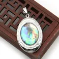 Macro view of silver oval locket featuring natural abalone shell inlay and scroll texture - Oval (25x38)