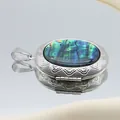 Detail macro of silver oval locket with colorful abalone shell and embossed patterns - Oval (39x52)