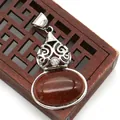 Vintage silver-plated goldstone pendant with floral relief and red-brown gemstone - Gold Sandstone