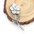 Detailed view of flower brooch with natural shell petals and pearl on a wood slice - White Daisy Style (No. 1)