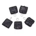 Detailed view of square black volcanic lava stone pendants with silver metal loops - 21 x 29 mm