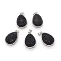 Macro detail of teardrop lava stone pendants with silver plated metal edging and bails - 20x31mm