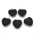 Detailed view of five heart-shaped natural black lava stone pendants with silver metal edging - 30x32mm