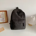 Minimalist black nylon backpack with woven rope zipper detail for students - Black