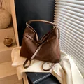 Large dark brown suede tote bag with decorative metal eyelet belts and sturdy handles - Brown