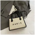 Minimalist beige woven tote bag with black leather trim and Paris text detail - Small Beige and Black