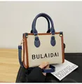 Retro-Canvas-Tragetasche in Beige mit marineblauen Ledergriffen und Umhängegurt-Design - Klein / Blau