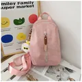 Light pink canvas crossbody bag with vertical zipper and cute white plush charm - With Charm / Pink