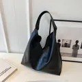 Minimalist black PU leather tote bag with unique diagonal stitching and wide strap - Black