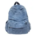 Minimalist light blue washed denim backpack with multiple pockets and top handle - Light Blue