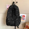 Black quilted backpack featuring white bow embroidery and long tassel zipper charms - No Charms / Black