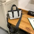 Lightweight white waterproof crossbody bag with black handles and adjustable shoulder strap - Silver Gray