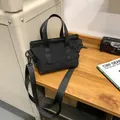 Versatile black nylon mini tote bag with adjustable strap for urban commuting style - Black