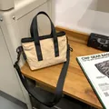 Minimalist beige nylon tote bag with black straps for urban commuting and daily casual use - Off White