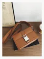 Brown leather crossbody messenger bag with silver metal buckle and wide shoulder strap - Brown