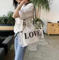 Transparent PVC tote bag with white LOVE inner pouch and black shoulder straps - Clear White