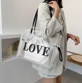 Transparent PVC tote bag with black LOVE print and white drawstring inner pouch - Matte White