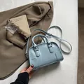 Light blue mini Boston bag with embossed lettering and adjustable shoulder strap - Blue