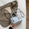 Elegante bolso de mano azul claro con relieve y correa ajustable sobre sábana blanca - Azul (Sin Colgante)