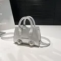 Mini silver metallic motor shell bag charm with dual handles and studs detail - Silver