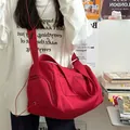 Large capacity red fitness travel bag with shoulder strap shown on female model - Red