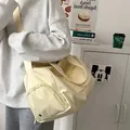 Detail view of the beige multi-purpose travel bag with side zipper and strap - Yellow