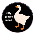 Round silly goosey mood metal enamel pin with white goose illustration on black background - Silly Goose Mood (Feeling Restless)