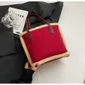 Detail of red suede tote with beige faux shearling trim and burgundy leather handles - Red